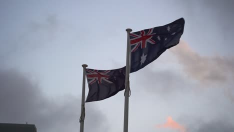 Slow-motion-shot-capturing-flag-of-Australia-and-New-Zealand-waving-side-by-side-against-the-sky,-natural-allies-with-a-strong-trans-Tasman-sense-of-family