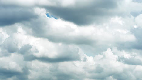 Cumulus-clouds-move-against-a-clear-blue-sky