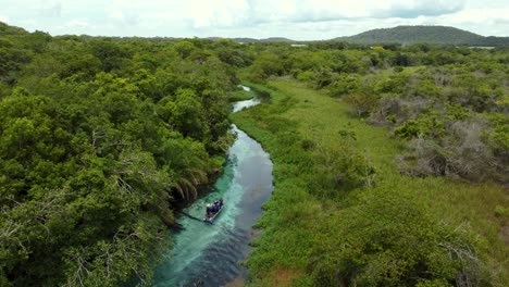 flying-over-a-Boat-in-the-crystalline-water-of-Sucuri-river---Bonito,-Mato-Grosso-do-Sul---Brazil