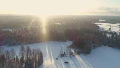 Aerial-view-beautiful-sunrise-over-snow-covered-nature-and-countryside