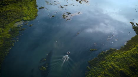 aerial-view-of-a-speed-boat-on-the-river-Parana-with-the-sky-mirrored-in-the-river