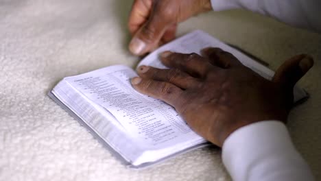 man-praying-to-god-with-hands-together-with-bible-Caribbean-man-praying-with-white-background-stock-footage