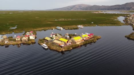 A-village-on-a-floating-island-on-Lake-Titicaca,-orbit-drone-shot