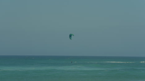 Man-Kite-Surfing-In-Ocean,-Extreme-summer-sport-slow-motion-in-Portugal