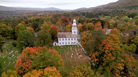 Bennington-Vermont-aerial-tilt-up-from-church-in-fall,-autumn