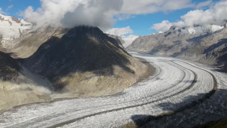 Slow-pan-right-while-flying-towards-the-Aletsch-Glacier,-Switzerland-during-the-day-in-summer