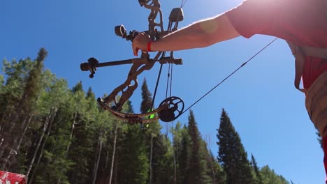 Slow-motion-shot-of-an-archer-shooting-an-arrow-in-the-mountains-3