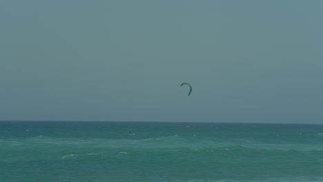 Young-Man-Kite-Surfing-In-Ocean,-Extreme-summer-sport-slow-motion-in-Portugal
