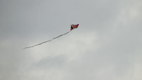Colorful-kite-in-cloudy-day-with-gray-clouds