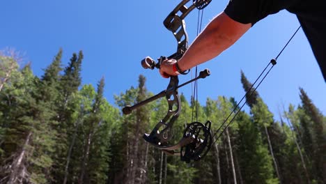 Slow-motion-shot-of-an-archer-shooting-an-arrow-in-the-mountains-4