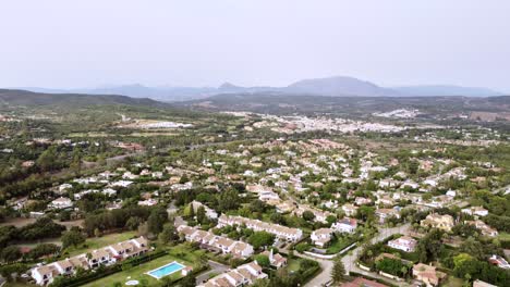 Static-aerial-view-Spanish-town-in-countryside-and-hills-in-summer