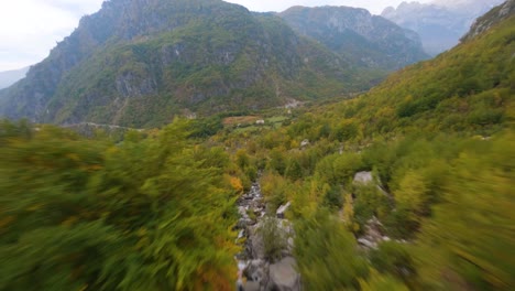 FPV-drone-dives-down-a-waterfall-in-Theth,-Albania