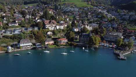 fantastic-aerial-shot-of-the-coast-of-the-municipality-of-Oberhofen-in-switzerland,-on-a-sunny-day