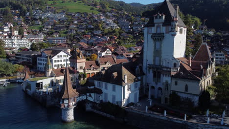 fantastic-aerial-close-up-shot-of-Oberhofen-castle-in-switzerland,-on-a-sunny-day
