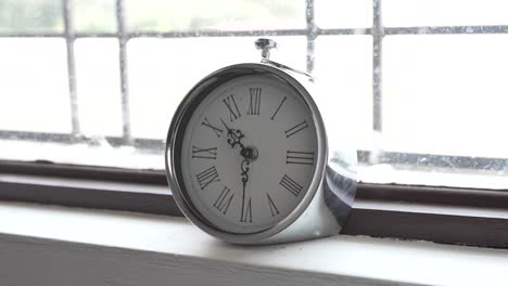 Silver-Clock-infront-of-Sunny-Window