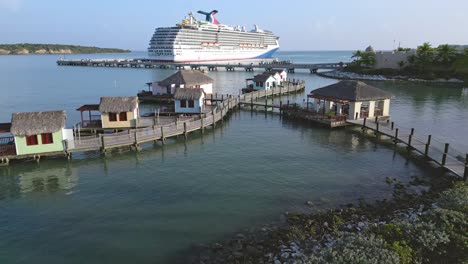 Ocean-villas-of-resort-in-Amber-Cove-with-cruise-ship-in-background,-Puerto-Plata-in-Dominican-Republic
