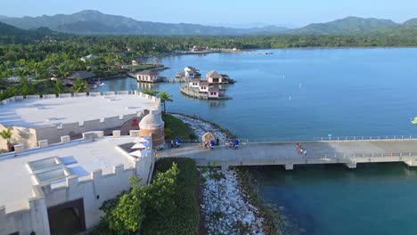 Flying-Over-Pier-Towards-Lounges-And-Cabanas-At-Amber-Cove-Cruise-Port-In-Puerto-Plata,-Dominican-Republic