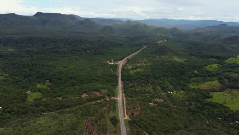 aerial-view-of-a-road-in-the-middle-of-a-mountainous-region---Chapada-dos-veadeiros,-Brazil