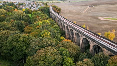 Drone-footage-of-the-Penistone-Railway-Station-and-stone-built-viaduct-near-Barnsley,-South-Yorkshire