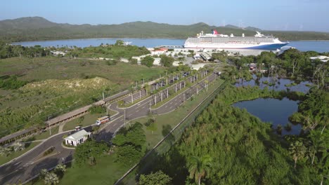 Aerial-view-of-entrance-at-Amber-Cove-Cruise-Park-Terminal-with-parking-Cruise-Ship-in-background---Puerto-Plata,Spain