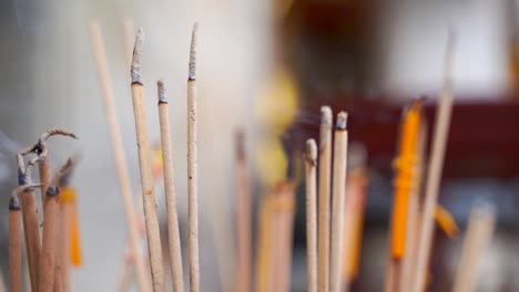 Handheld-close-up-view-of-Incense-burning-with-background-blur