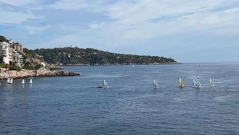 Panning-view-of-group-of-sailboats-sailing-for-regatta-race-along-coast-of-Nice-in-France