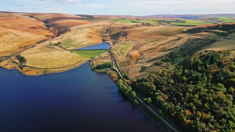 Aerial-drone-video-footage-taken-at-the-town-of-Ogden-Saddleworth-moor-in-Oldham,-England-of-a-series-of-Lakes,-Reservoirs,-set-against-a-backdrop-of-moorland-and-woodlands