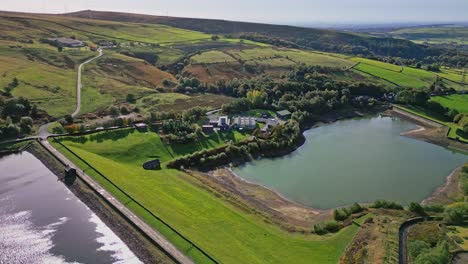 Aerial-drone-video-footage-taken-at-Ogden-near-Saddleworth-moor-of-a-series-of-Lakes,-Reservoirs,-set-against-a-backdrop-of-moorland-and-woodlands