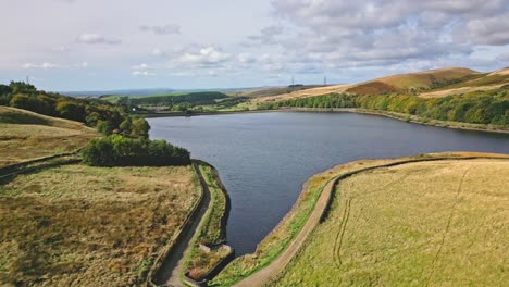 Aerial-drone-video-footage-taken-near-Saddleworth-moor-in-Oldham,-England-of-a-series-of-Lakes,-Reservoirs,-set-against-a-backdrop-of-moorland-and-woodlands