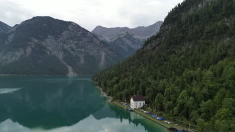 Lake-in-Tyrol-Austria-clear-still-water-early-morning-drone-view