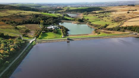 Aerial-drone-video-footage-taken-near-Windy-Hill-Saddleworth-moor-of-a-series-of-Lakes,-Reservoirs,-set-against-a-backdrop-of-moorland-and-woodlands
