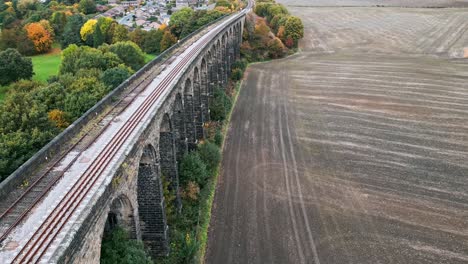 Sweeping-drone-footage-of-the-Penistone-Railway-Station-and-Viaduct-near-Barnsley,-South-Yorkshire