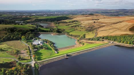 High-up-aerial-drone-video-footage-taken-at-Ogden-Saddleworth-moor-in-Oldham,-England-of-a-series-of-Lakes,-Reservoirs,-set-against-a-backdrop-of-moorland,-woodlands-and-farmland-pastures