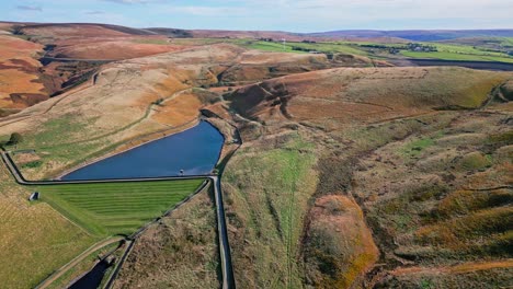 Aerial-drone-video-footage-taken-at-Ogden-Saddleworth-moor-in-Oldham,-England-of-a-series-of-Lakes,-Reservoirs,-set-against-a-backdrop-of-moorland-and-woodlands