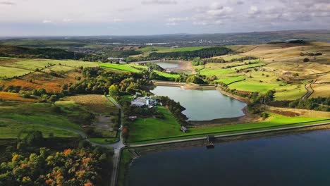 Aerial-drone-video-footage-taken-at-Ogden-moor,-Saddleworth-in-Oldham,-England-of-a-series-of-Lakes,-Reservoirs,-set-against-a-backdrop-of-moorland,-woodlands-and-farmland-pastures