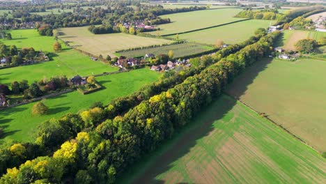Kent-countryside-scene-in-Autumn-from-a-drone-with-Autumn-coloured-trees-and-a-railway-track