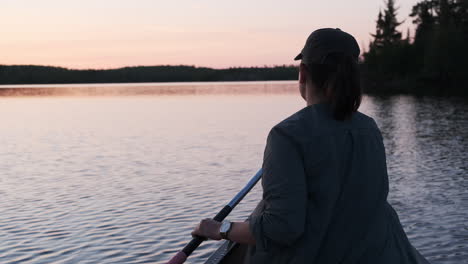 Adventurous-Woman-Paddling-In-Canoe-at-Sunset