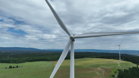 Wind-Turbine-and-Spinning-Blades,-Close-Up-Aerial-View