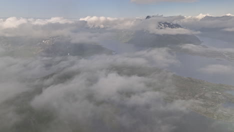 Djevelporten-Norway-Aerial-v5-spectacular-high-altitude-drone-flyover-patches-of-sparse-clouds-capturing-husvågen-bay-and-rugged-mountainscape-from-above---Shot-with-Mavic-3-Cine---June-2022