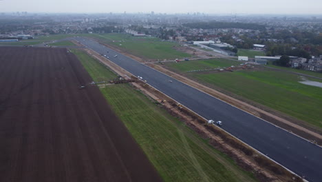 Construction-Works-on-the-Runway-of-Antwerp-Airport,-Cloudy-Day-Aerial