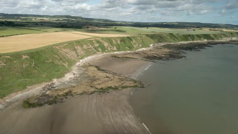 Aerial-panning-view-of-Jackson's-Bay,-North-Yorkshire,-Scarborough