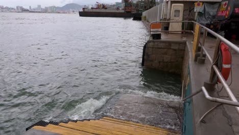 Sea-currents-splash-water-at-the-harbor-waterfront-deck-after-a-severe-tropical-typhoon-storm,-which-sustained-winds-of-63-miles-,-traveled-through-the-city-of-Hong-Kong