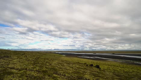 Beautiful-relaxed-timelapse-of-clouds-moving-over-a-river-with-mountains-in-the-background-in-a-typical-Iceland-landscape-in-4k