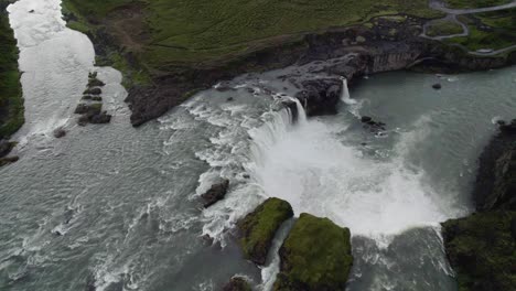 Drone-flying-over-large-circulair-formed-waterfall-with-the-camera-tilted-downwards-in-Iceland-in-4k