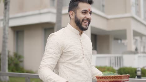 Handsome-Groom-Walking-Happily,-Holding-An-Indian-Prayer-Item-On-His-Hand