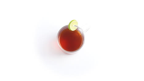 lemon-tea-in-a-transparent-glass-cup-with-sliced-lemon-in-white-background-rotating-top-shot