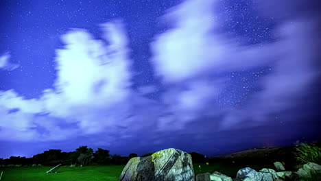 Timelapse:-Starry-night-at-satellite-station-with-rocky-boulder-at-a-field-valley