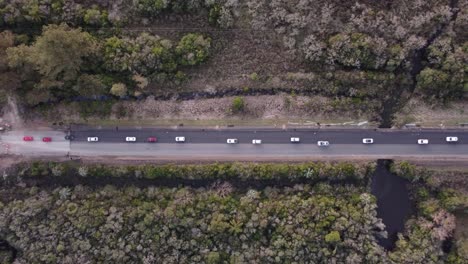 A-dynamic-top-down-aerial-footage-of-moderate-traffic-of-vehicles-on-a-highway-in-Uruguay,-South-America