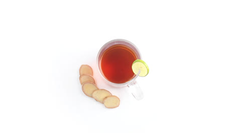 lemon-tea-in-a-transparent-glass-cup-with-sliced-lemon-and-ginger-in-white-background-rotating-side-shot