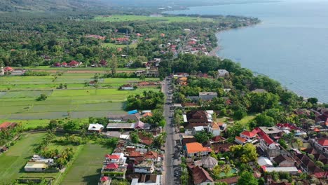 aerial-panoramic-view-of-road-on-Lovina-coastline-in-Bali-Indonesia-with-beautiful-ocean-on-sunny-day